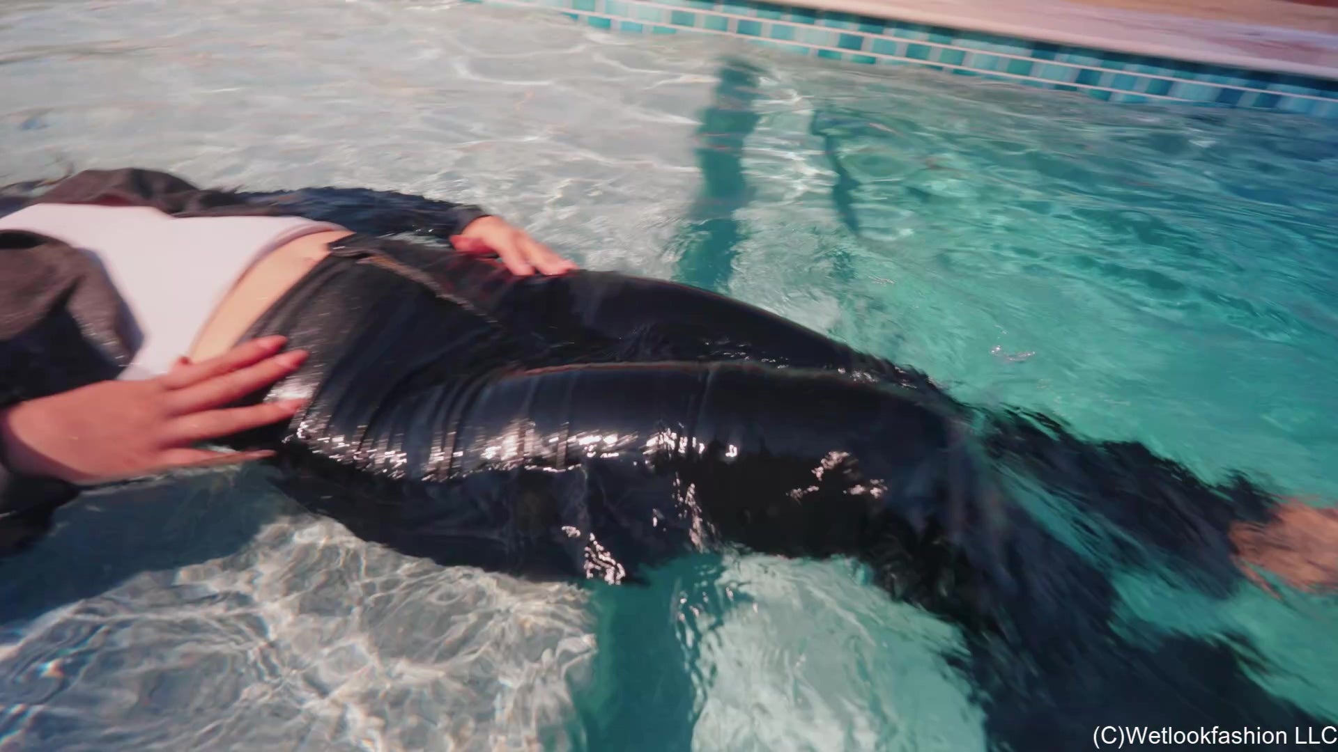 Alexandra Enjoys the Pool Wearing a Black Pant Suit