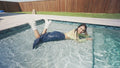 Alexandra Takes a Dip Wearing a Jean Skirt, Top and Boots