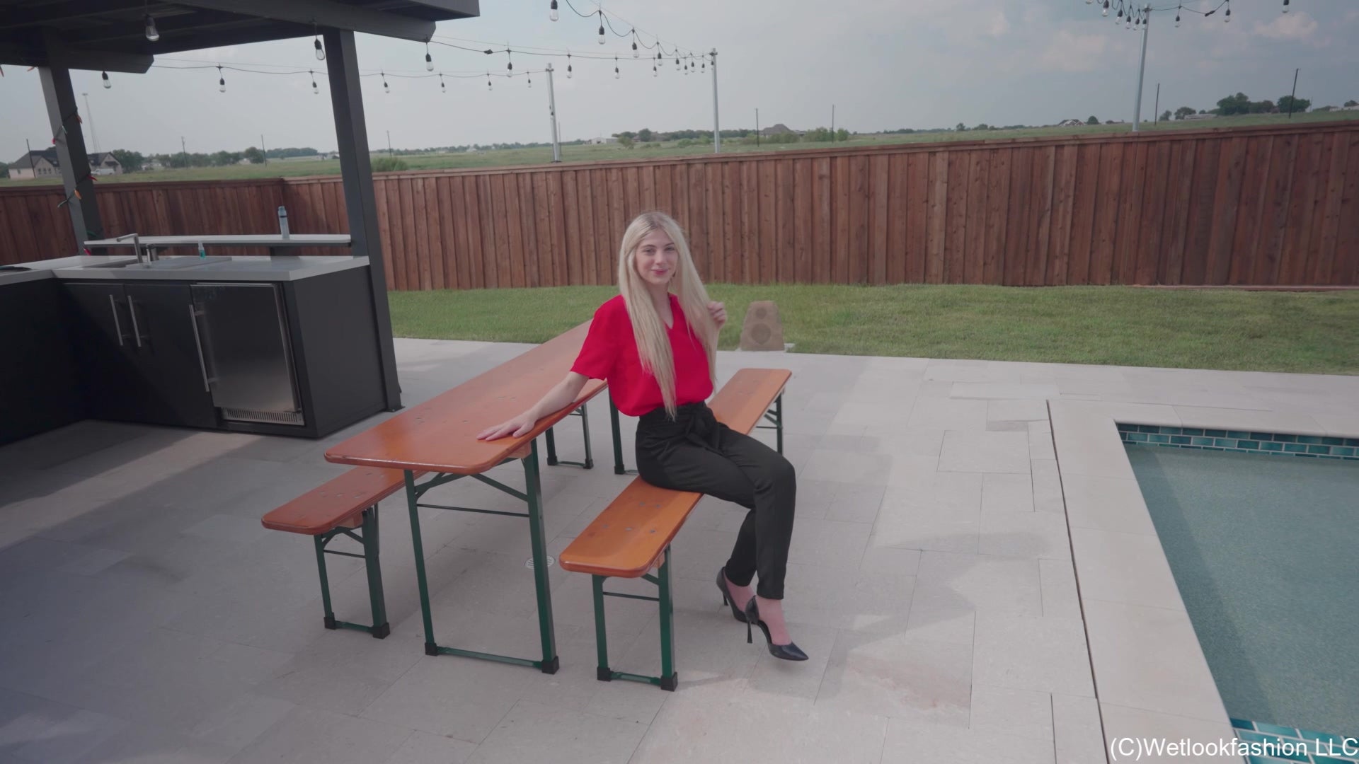 Amber Enjoys the Pool Wearing Black Pants and a Red Shirt