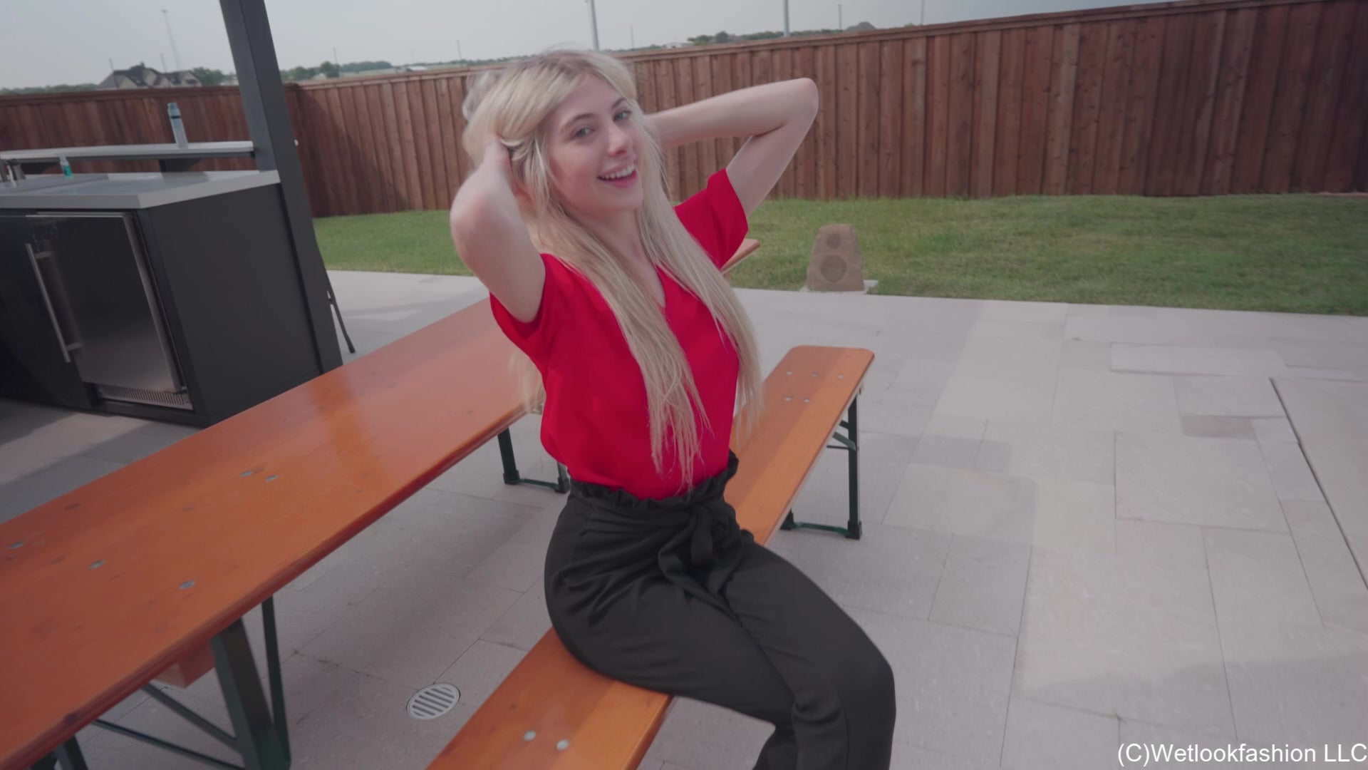 Amber Enjoys the Pool Wearing Black Pants and a Red Shirt