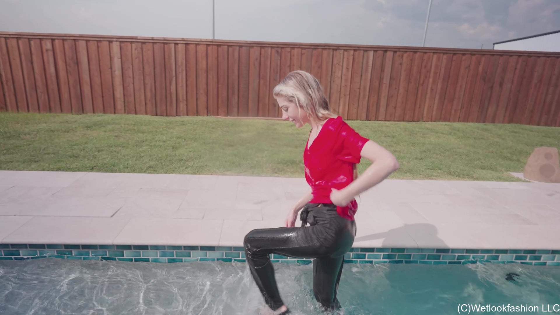 Amber Enjoys the Pool Wearing Black Pants and a Red Shirt