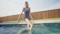 Amber Gets Wet in a Sporty Jumpsuit and Sneakers