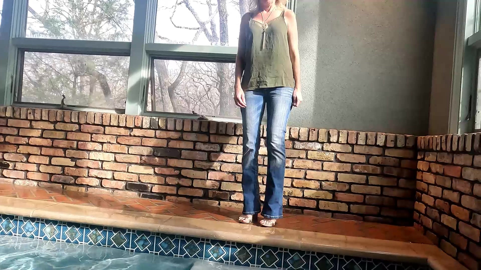 Angel Swims in Blue Jeans and Green Top