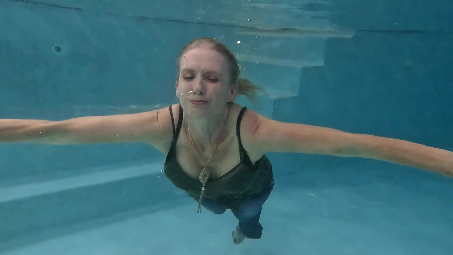 Angel Swims in Blue Jeans and Green Top