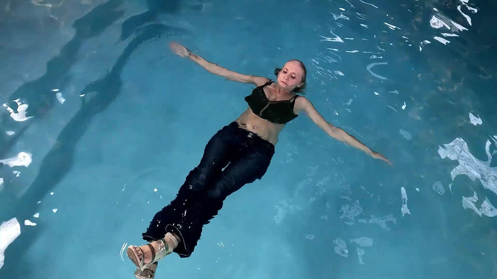 Angel Swims in Blue Jeans and Green Top