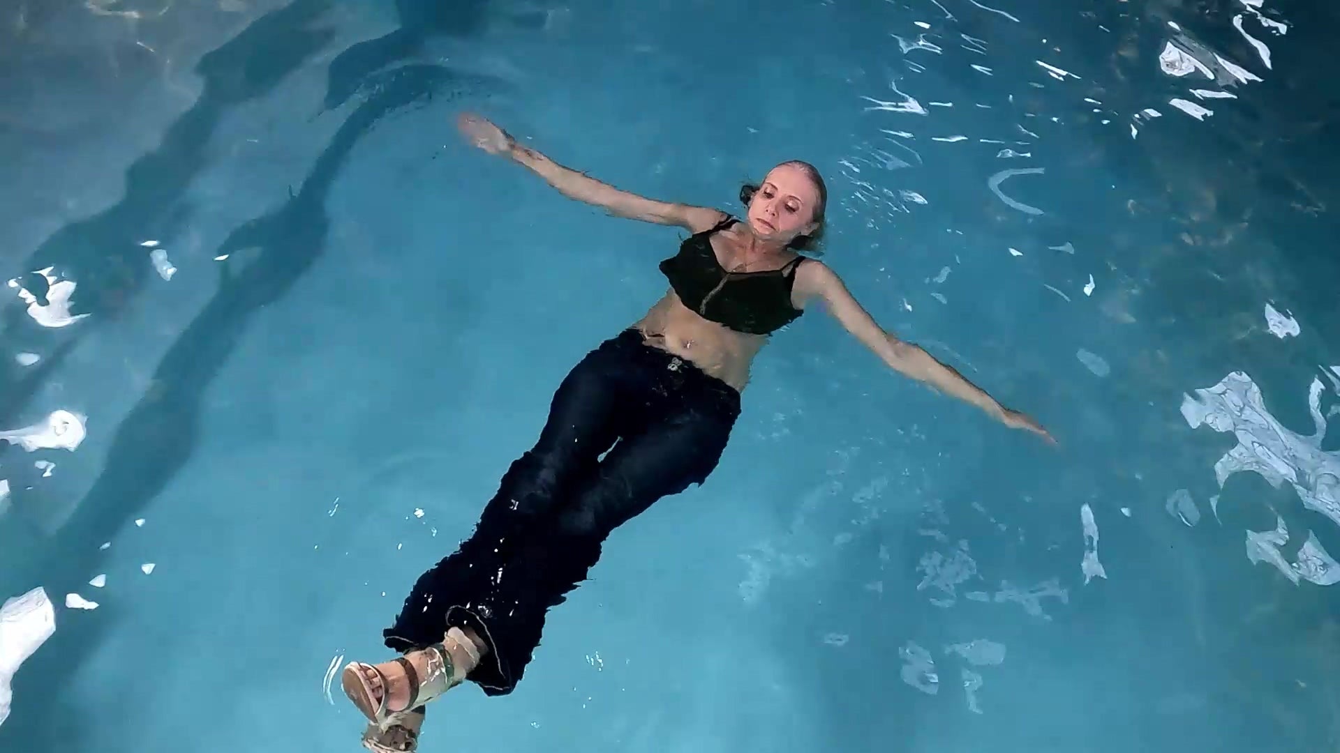Angel Swims in Blue Jeans and Green Top