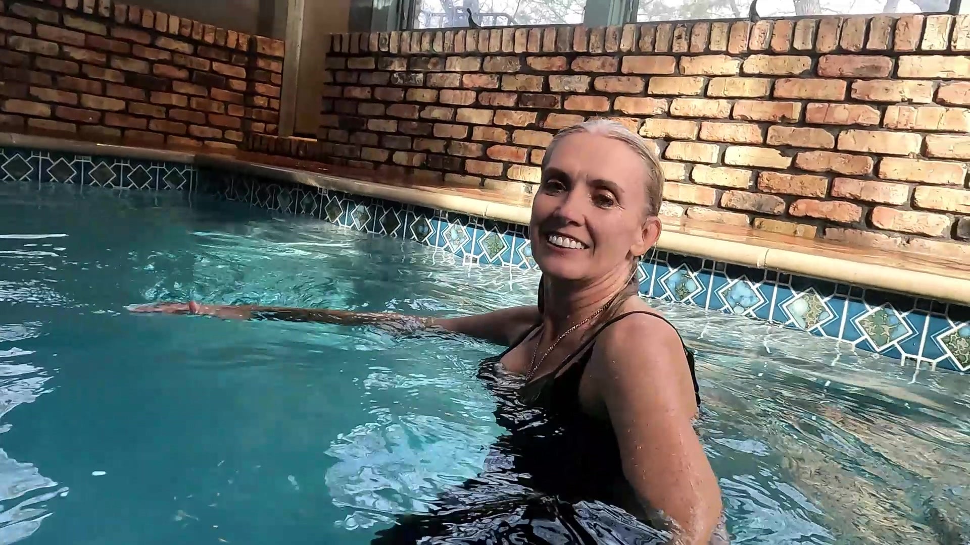 Angel Swims in Blue Jeans and Green Top