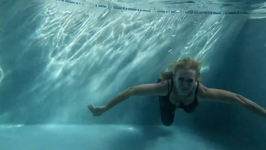 Angel Swims in Blue Jeans and Green Top