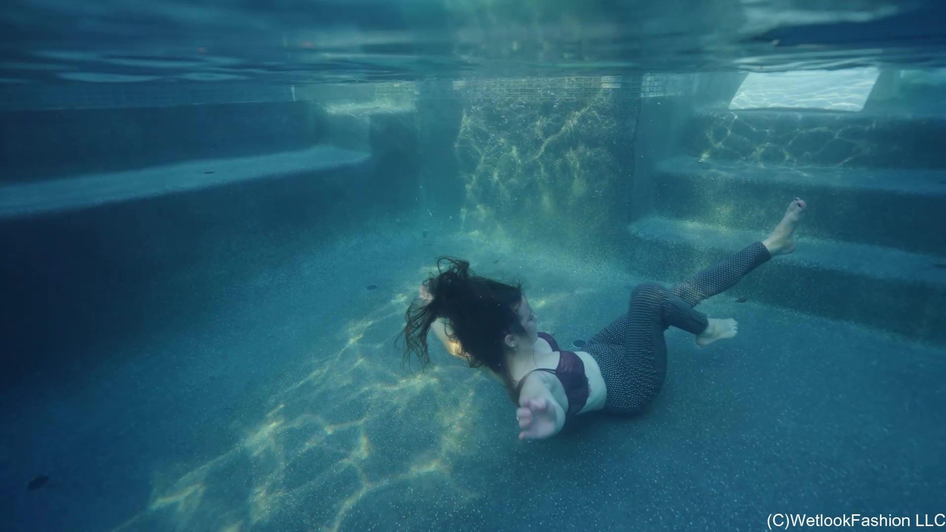 Rey Swims in Jeans, a Shirt and Barefoot