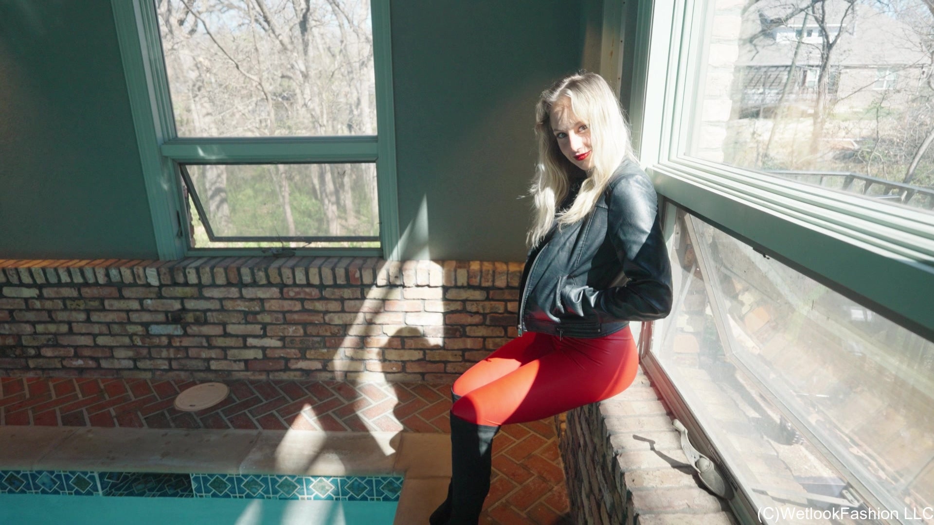 Camille in the Pool Wearing a Red and Black Leather Outfit