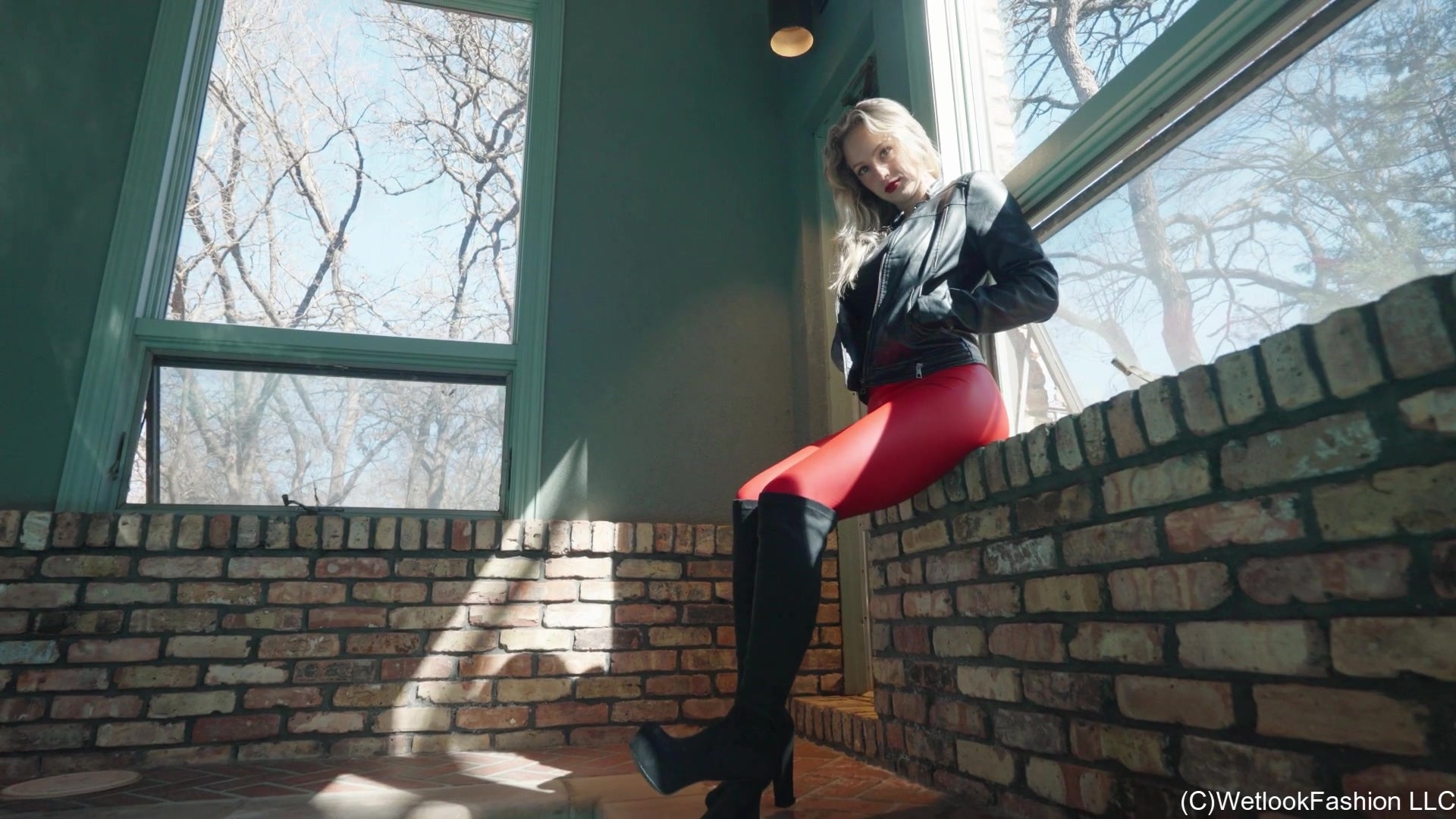 Camille in the Pool Wearing a Red and Black Leather Outfit