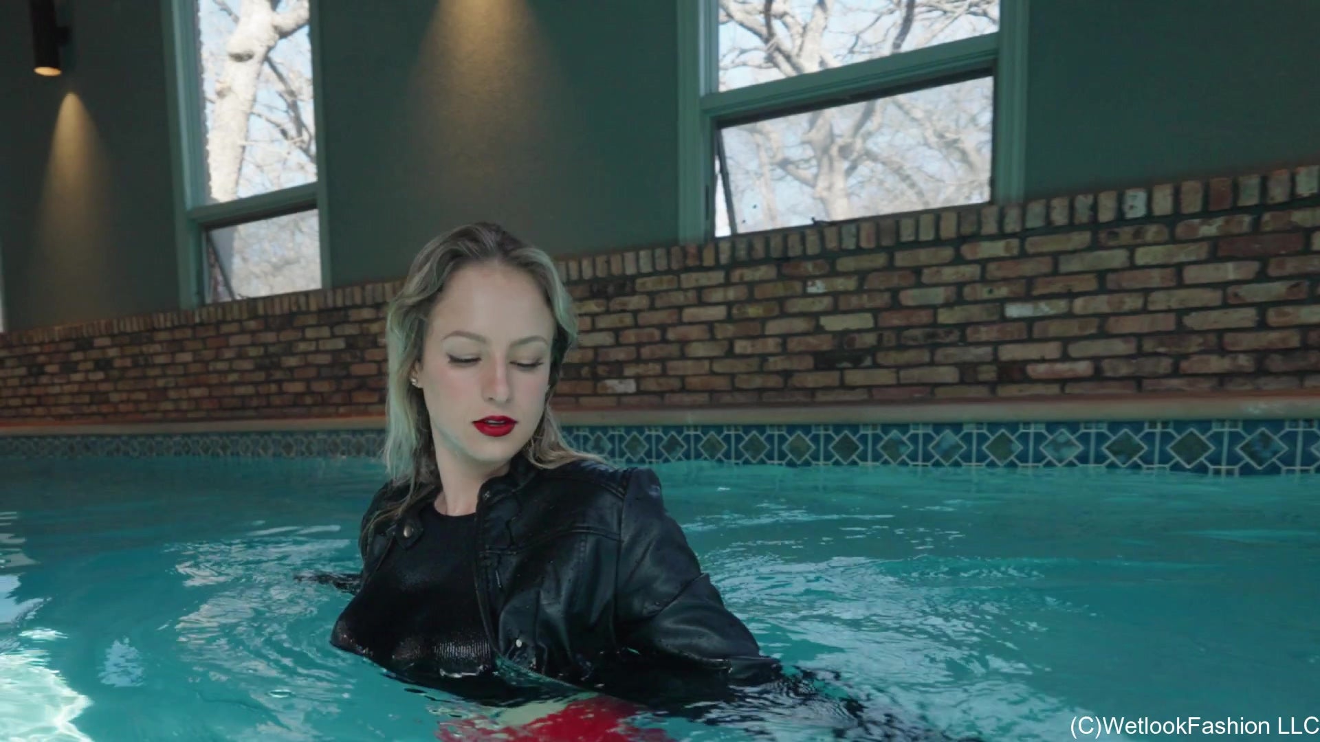 Camille in the Pool Wearing a Red and Black Leather Outfit