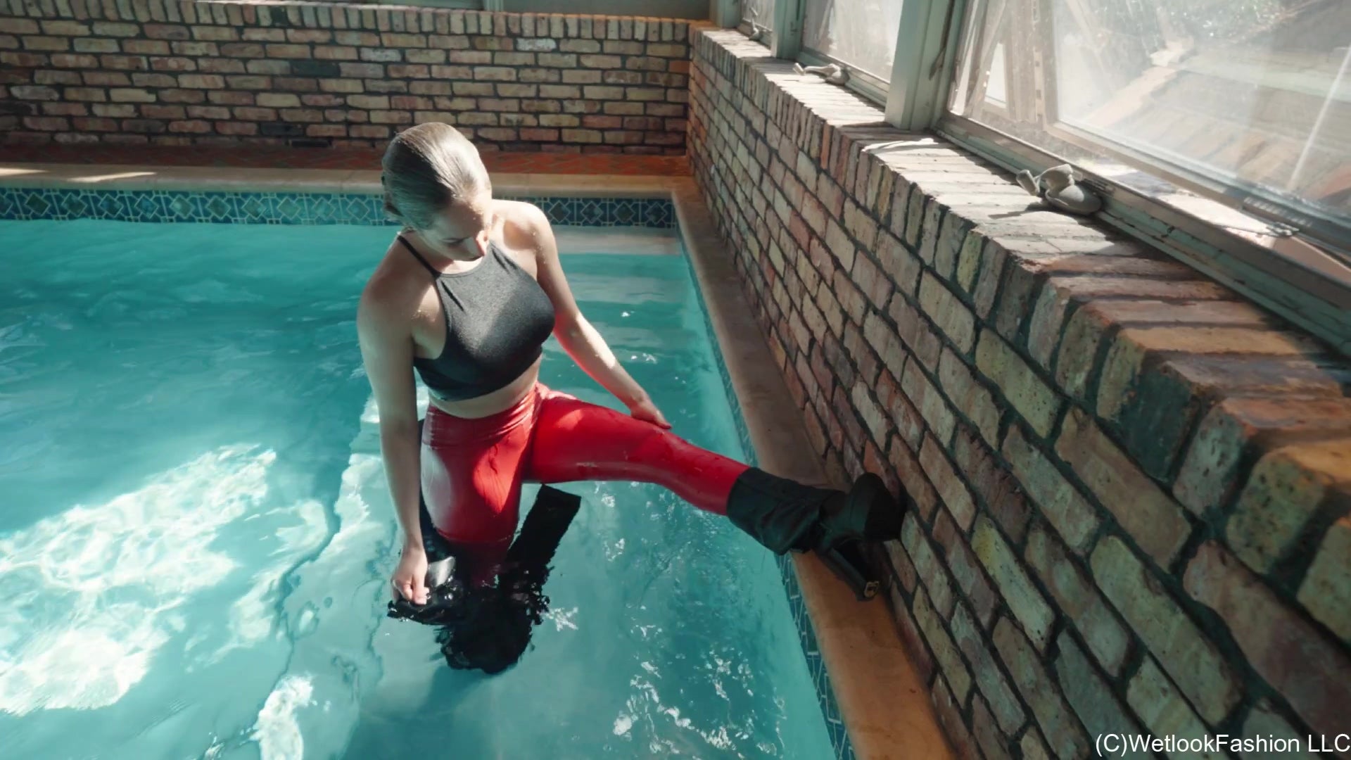 Camille in the Pool Wearing a Red and Black Leather Outfit