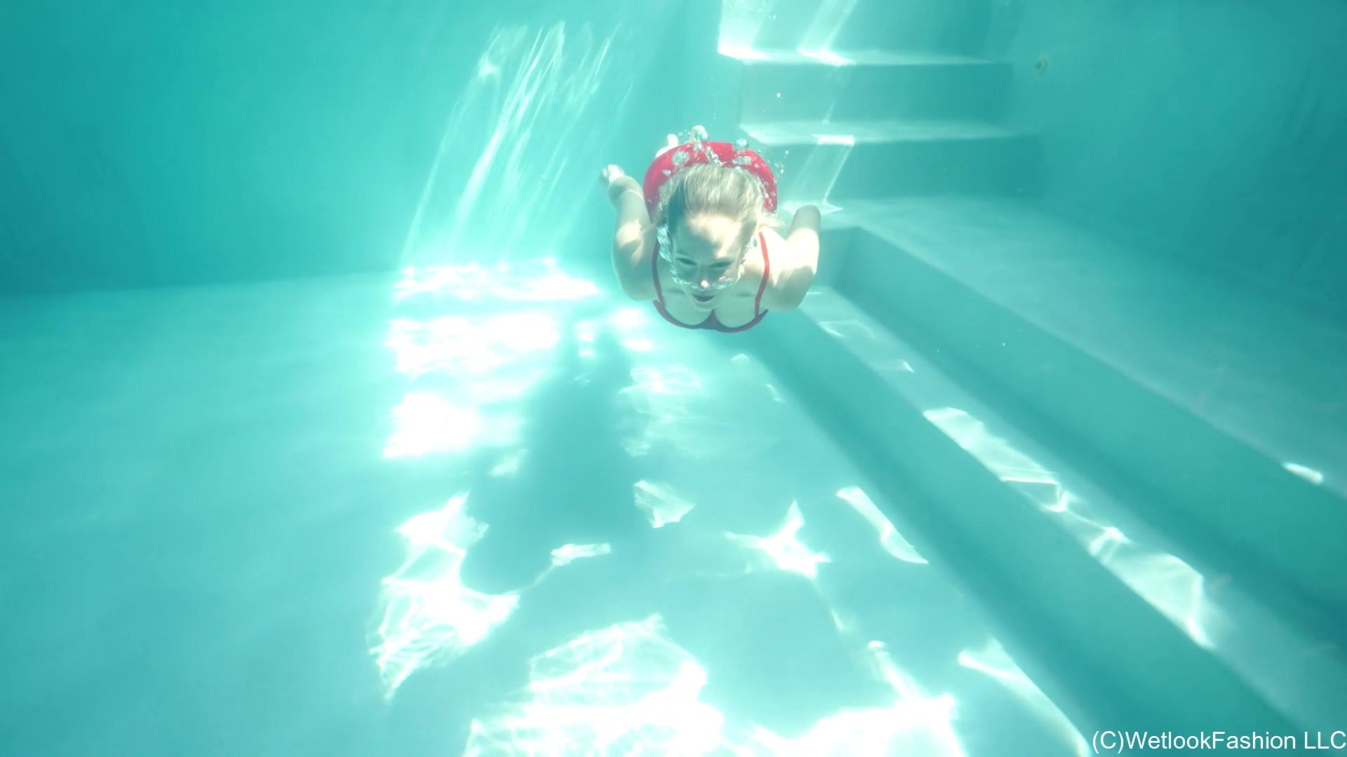 Camille wears a Short Red Dress in the Pool