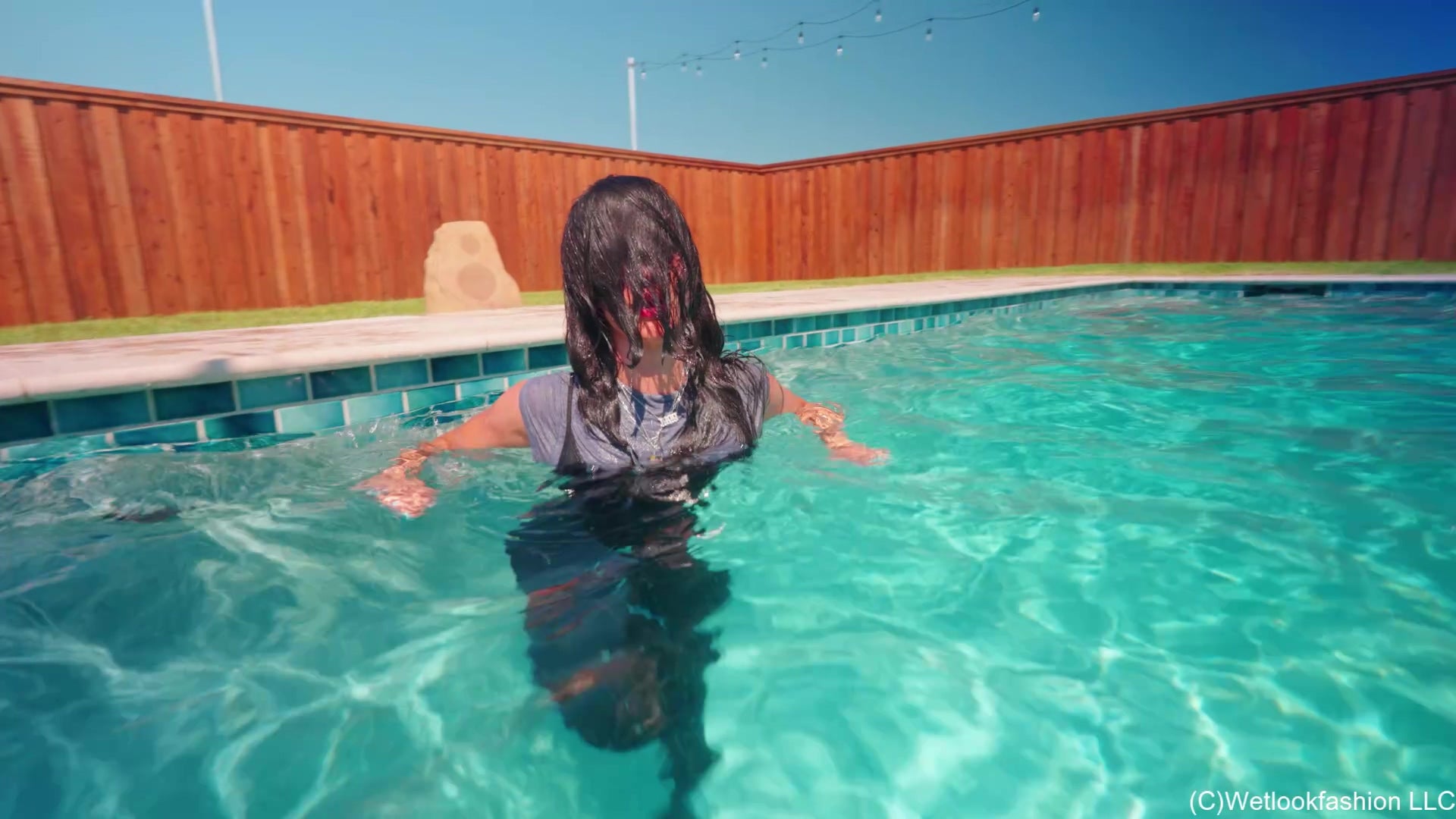 Carla Gets Wet in a Shiny Jumpsuit, Boots and a Shirt