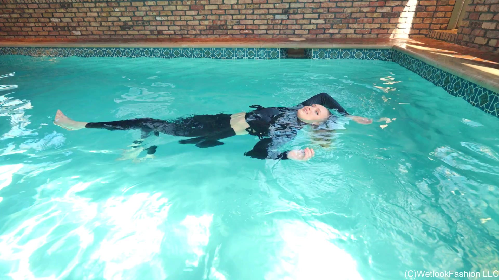 Gigi Swims Wearing Leggings and a Sweater