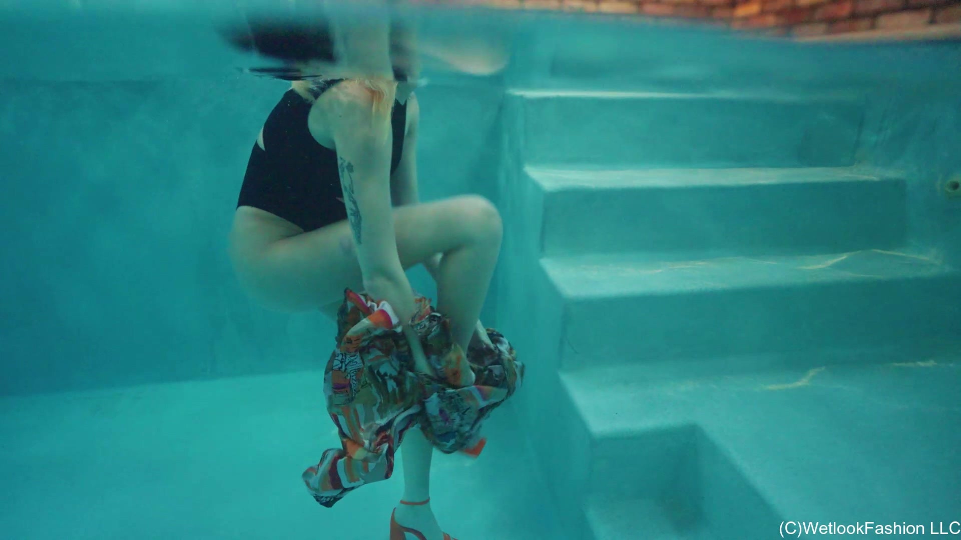 Gigi Is Swimming in a Bodysuit and a Long Satin Skirt