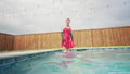 Jessica Has Some Pool Fun Wearing a Red Satin Dress