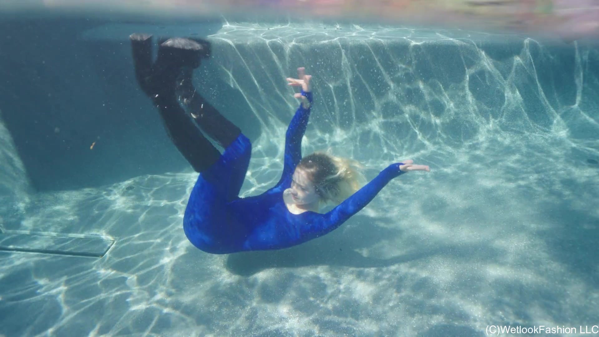 Jessica Takes a Dip Wearing a Jumpsuit, Boots and a Vest