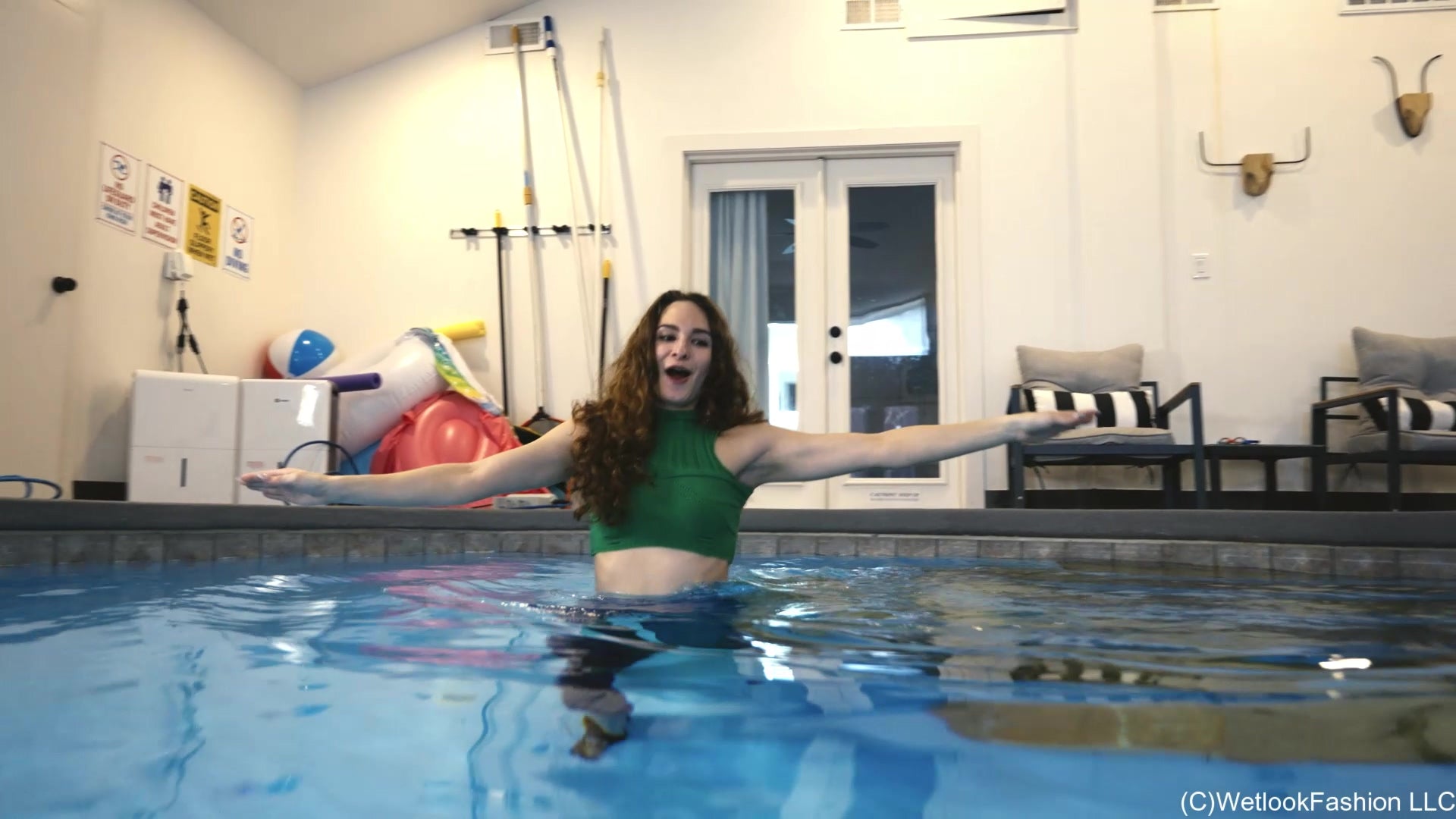 Lilith Swims in Flared Blue Jeans, Crop Top and High Heels