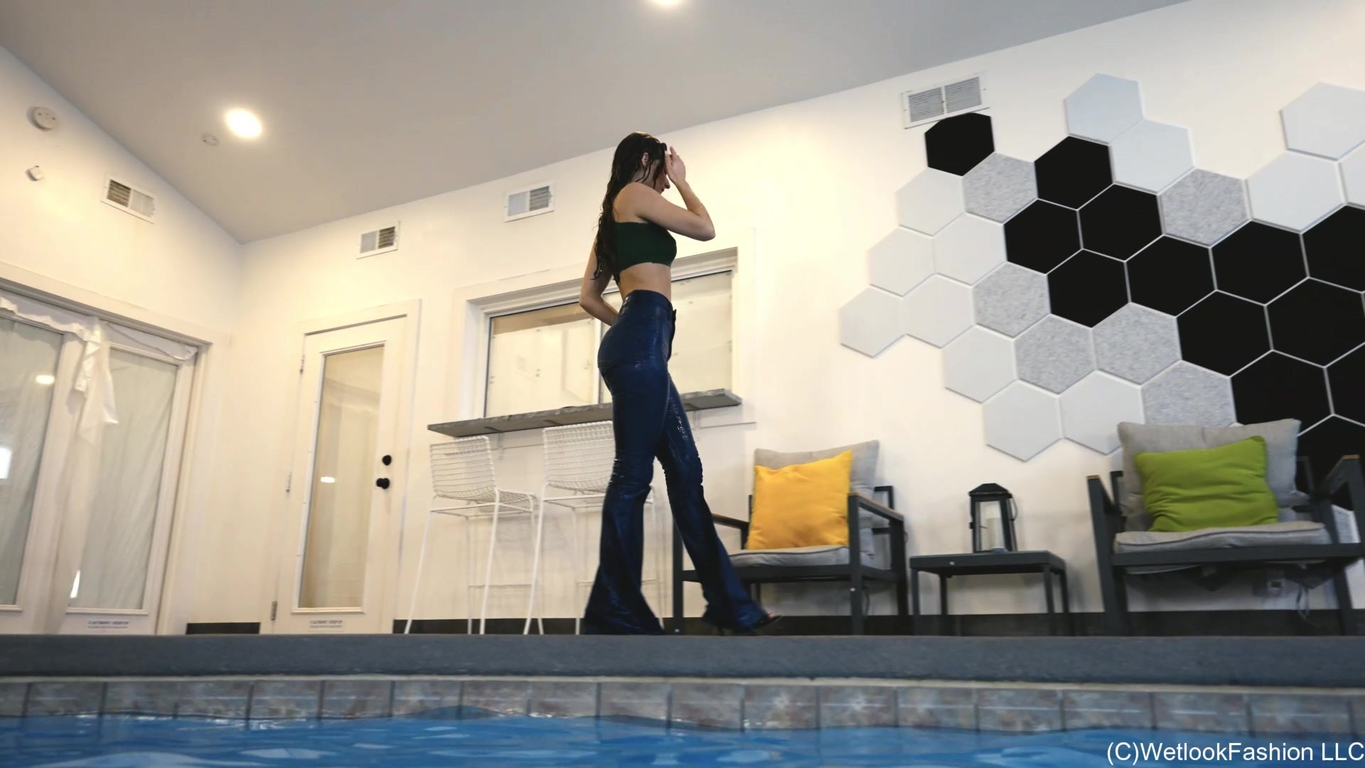 Lilith Swims in Flared Blue Jeans, Crop Top and High Heels