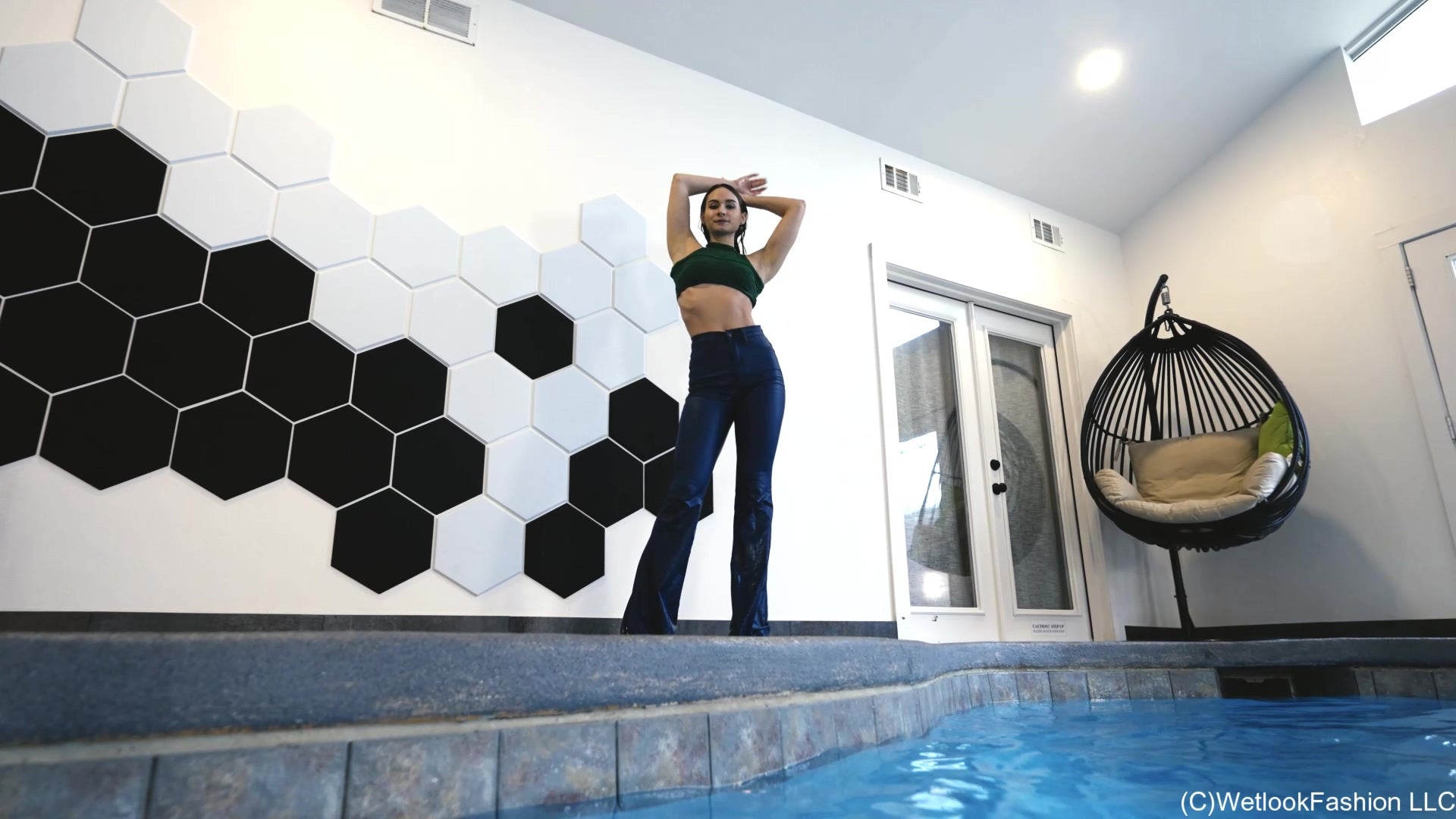 Lilith Swims in Flared Blue Jeans, Crop Top and High Heels