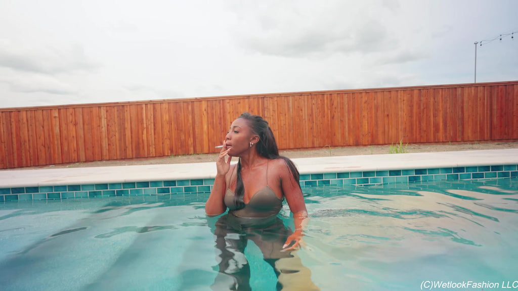 Naomi Is Smoking and Swimming in a Pantsuit