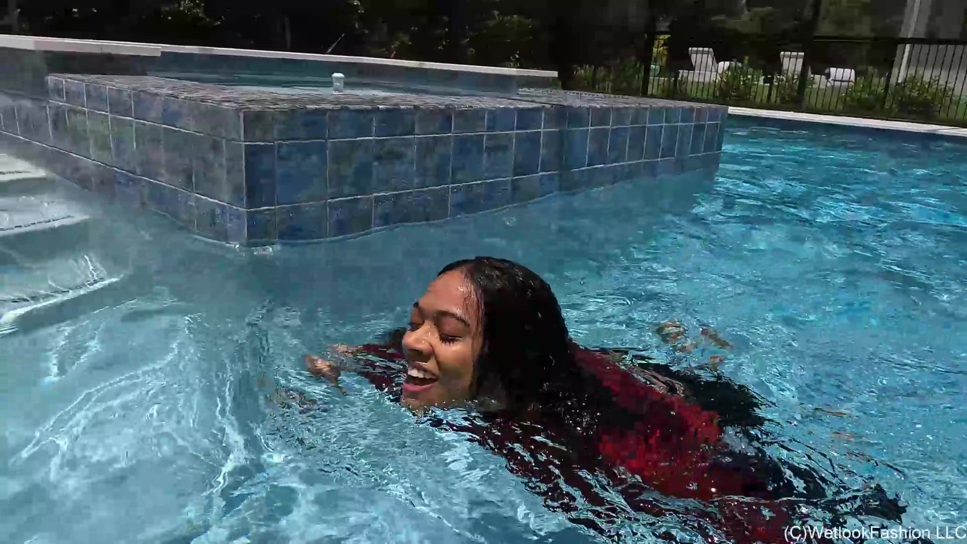 Natalie Swims in a Red and Black Business Outfit