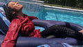 Natalie Swims in a Red and Black Business Outfit
