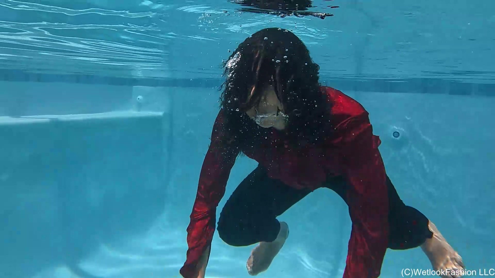 Natalie Swims in a Red and Black Business Outfit