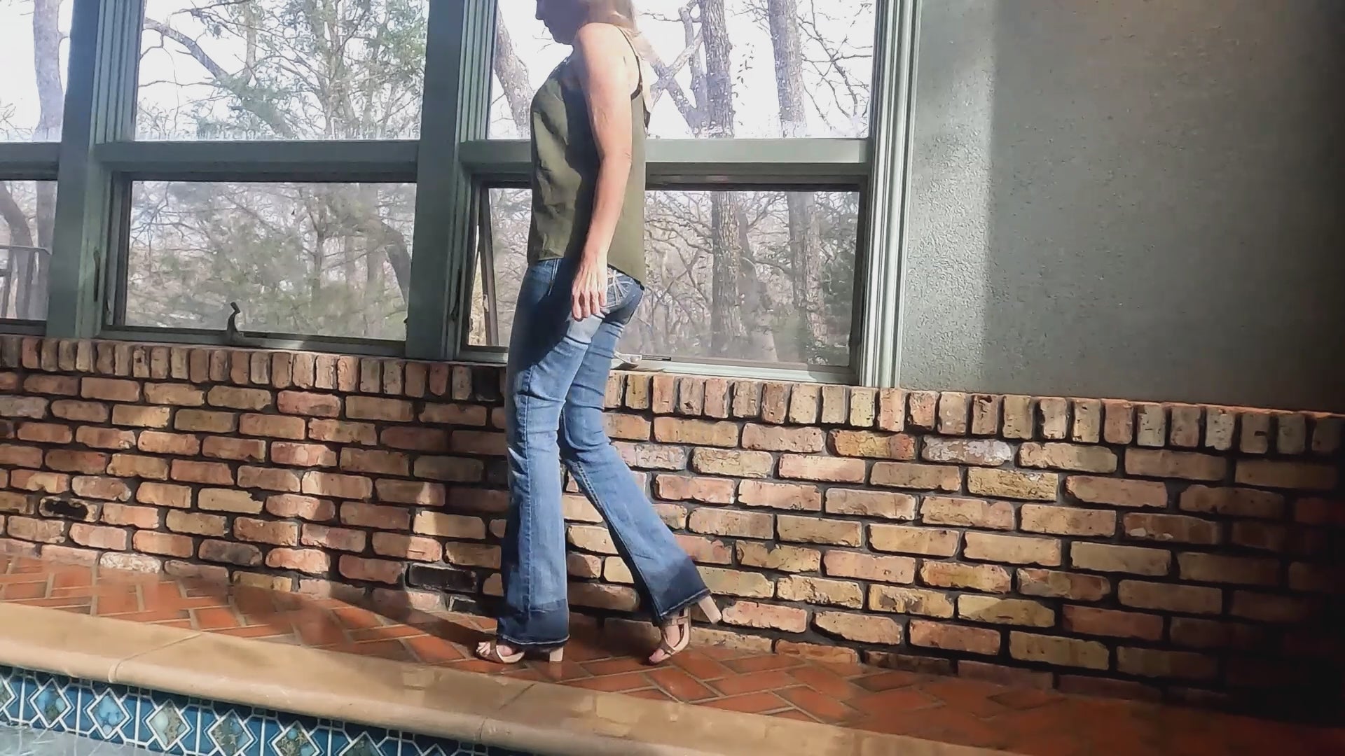 Angel Swims in Blue Jeans and Green Top