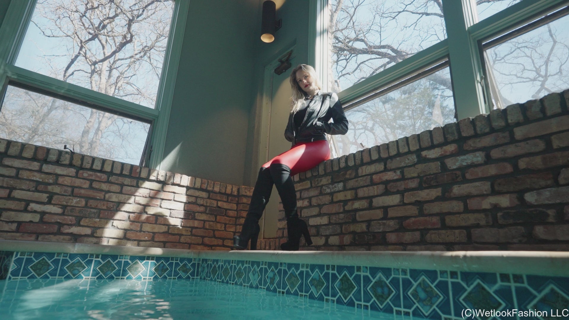 Camille in the Pool Wearing a Red and Black Leather Outfit