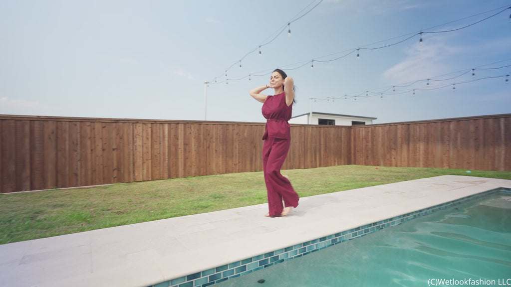 Reina Dives in the Pool Wearing a Pant Suit