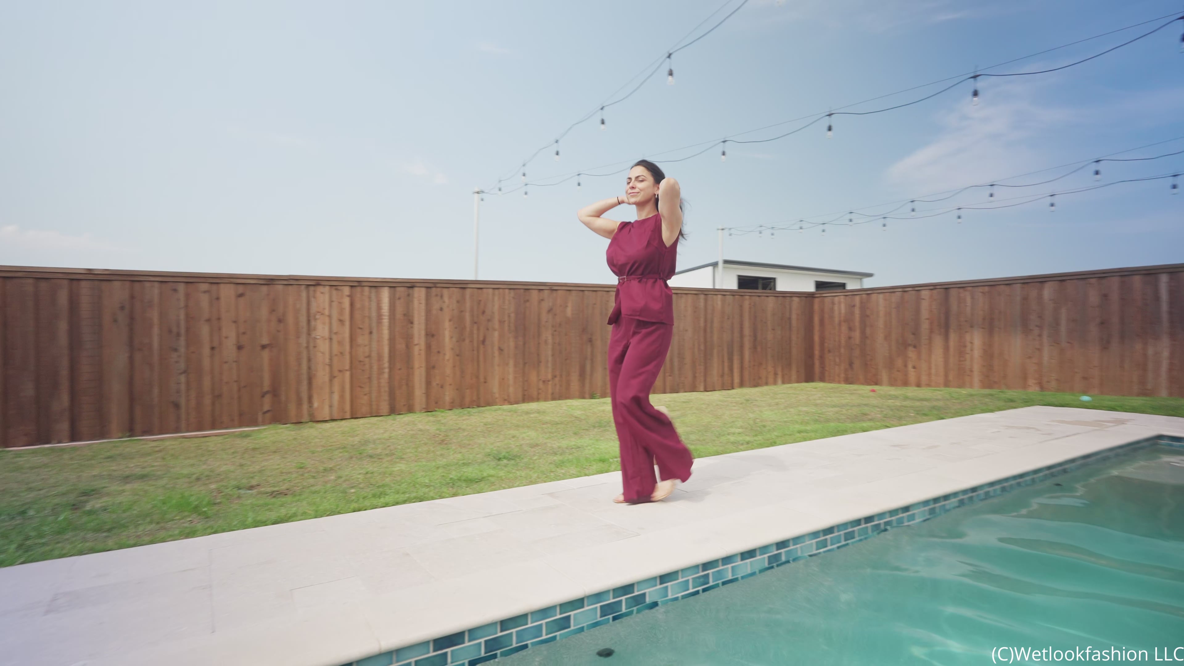 Reina Dives in the Pool Wearing a Pant Suit