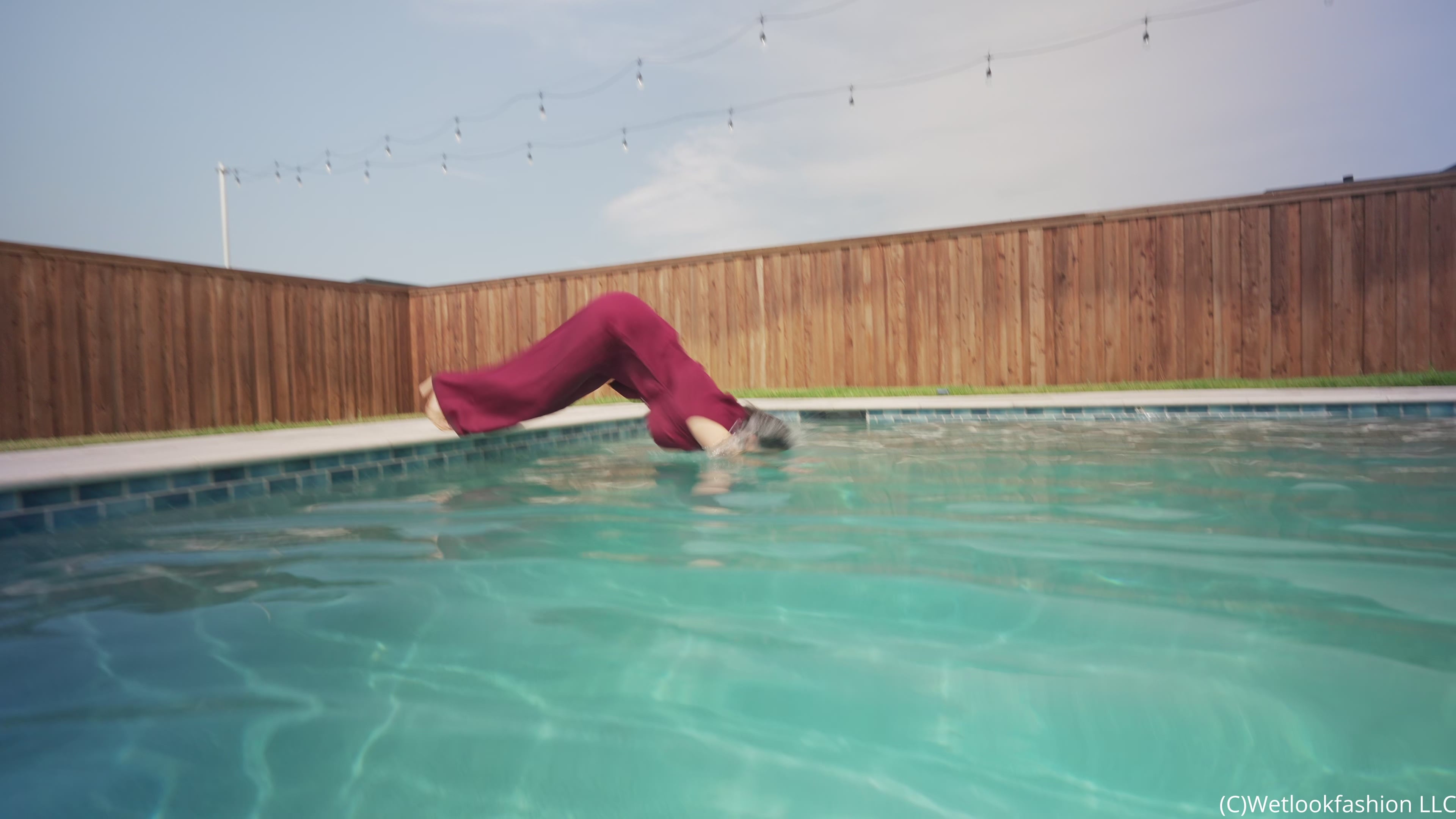 Reina Dives in the Pool Wearing a Pant Suit
