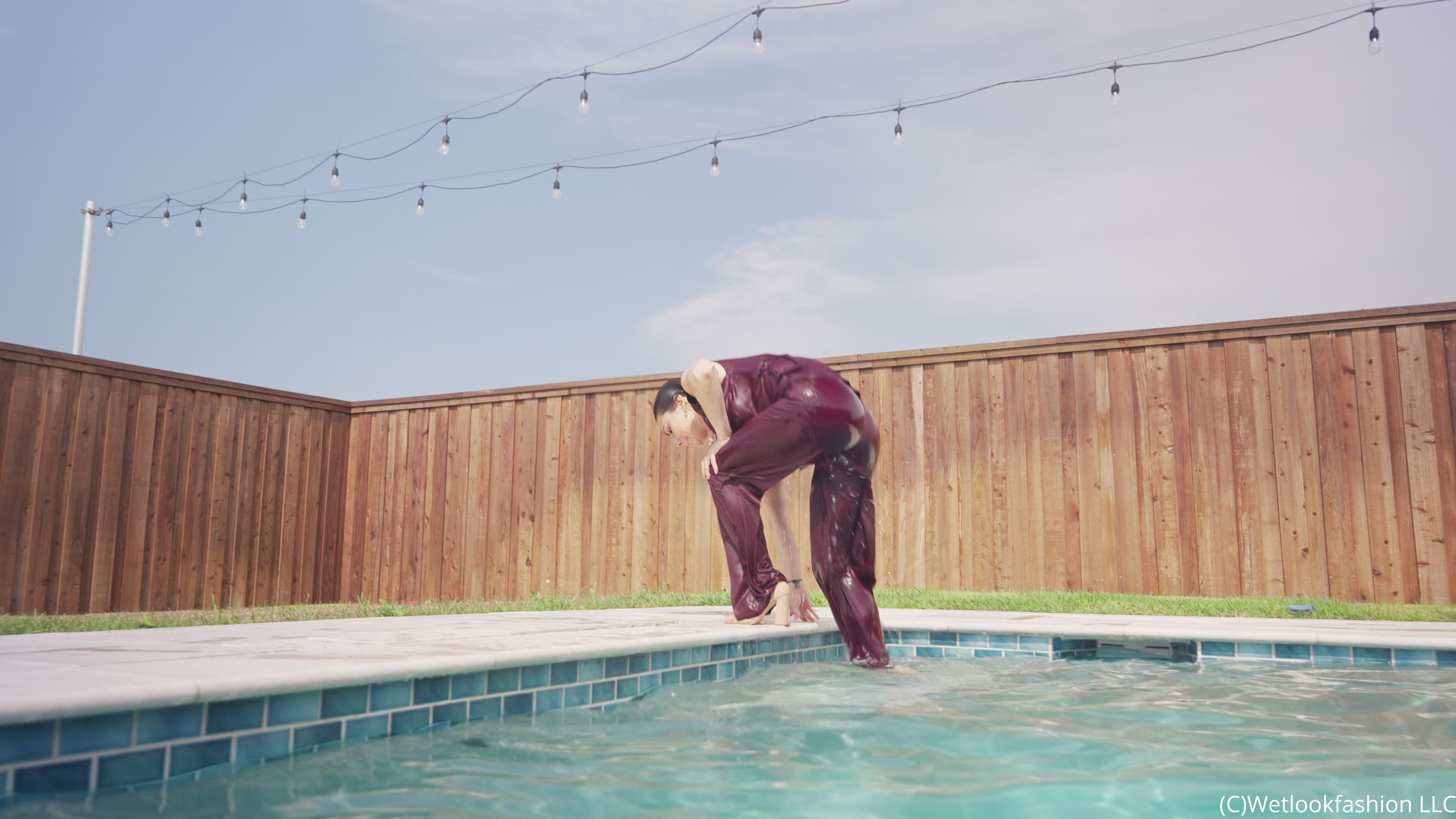 Reina Dives in the Pool Wearing a Pant Suit