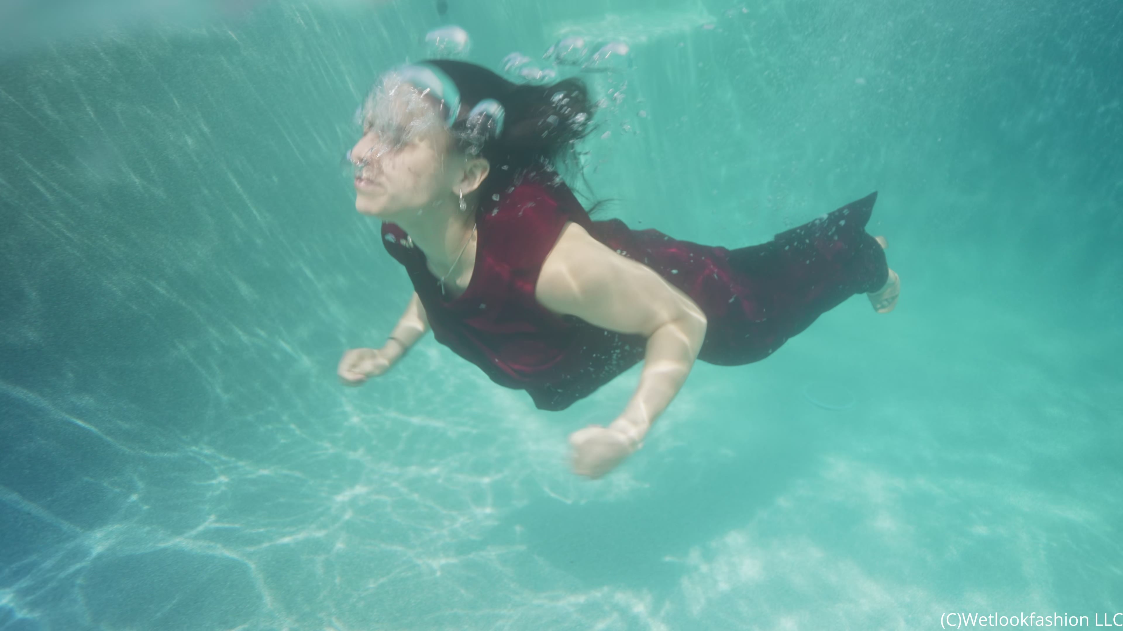 Reina Dives in the Pool Wearing a Pant Suit