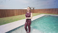 Reina Dives in the Pool Wearing a Pant Suit