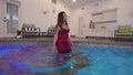Reyna Relaxing in the Pool Wearing a Red Cocktail Dress