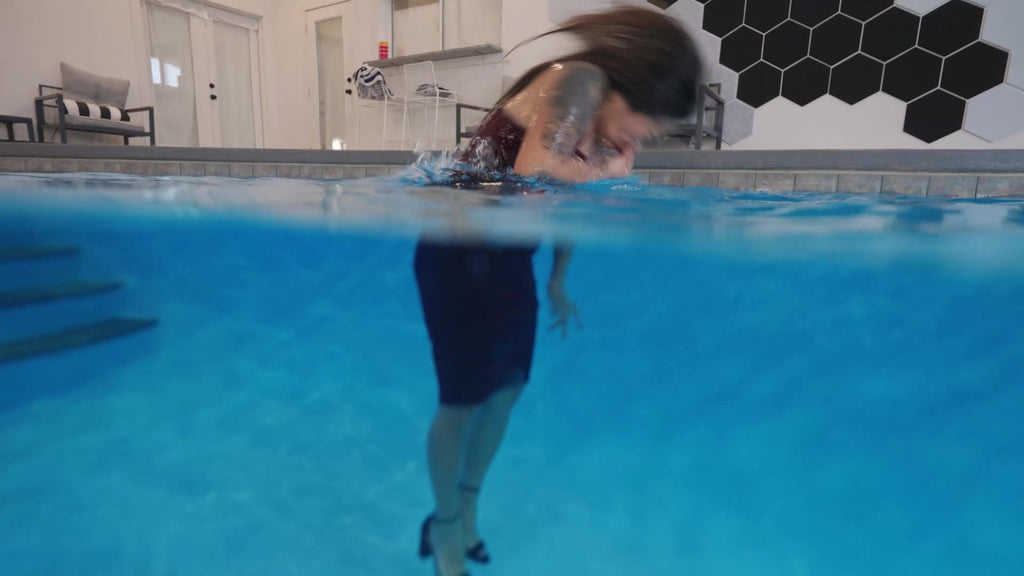 Reyna Relaxing in the Pool Wearing a Red Cocktail Dress