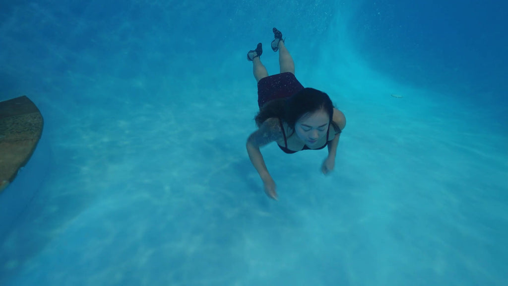 Reyna Relaxing in the Pool Wearing a Red Cocktail Dress