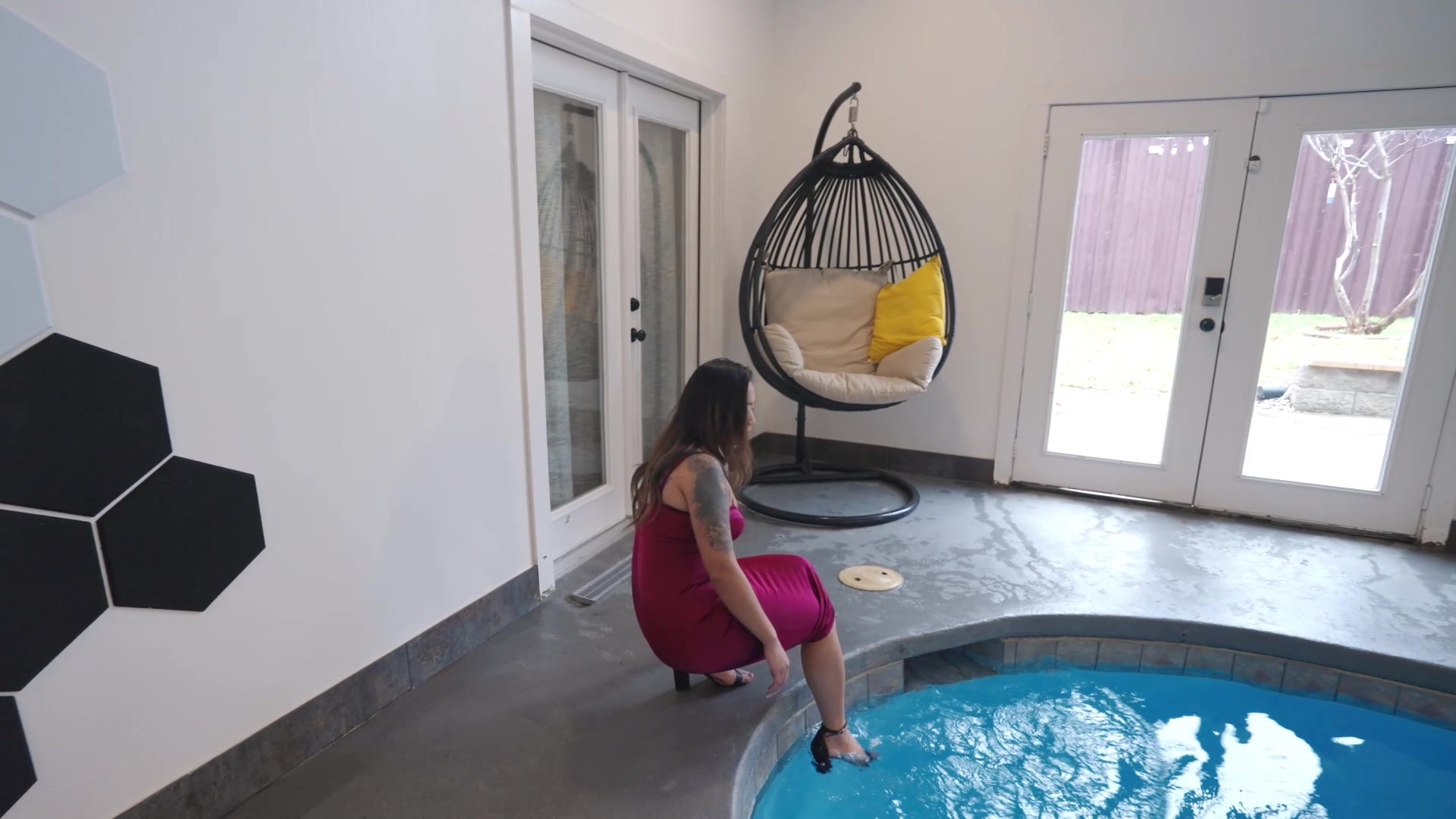 Reyna Relaxing in the Pool Wearing a Red Cocktail Dress